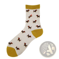 White cotton crew socks featuring playful brown and black dog cartoons with a red hat and mustard yellow accents