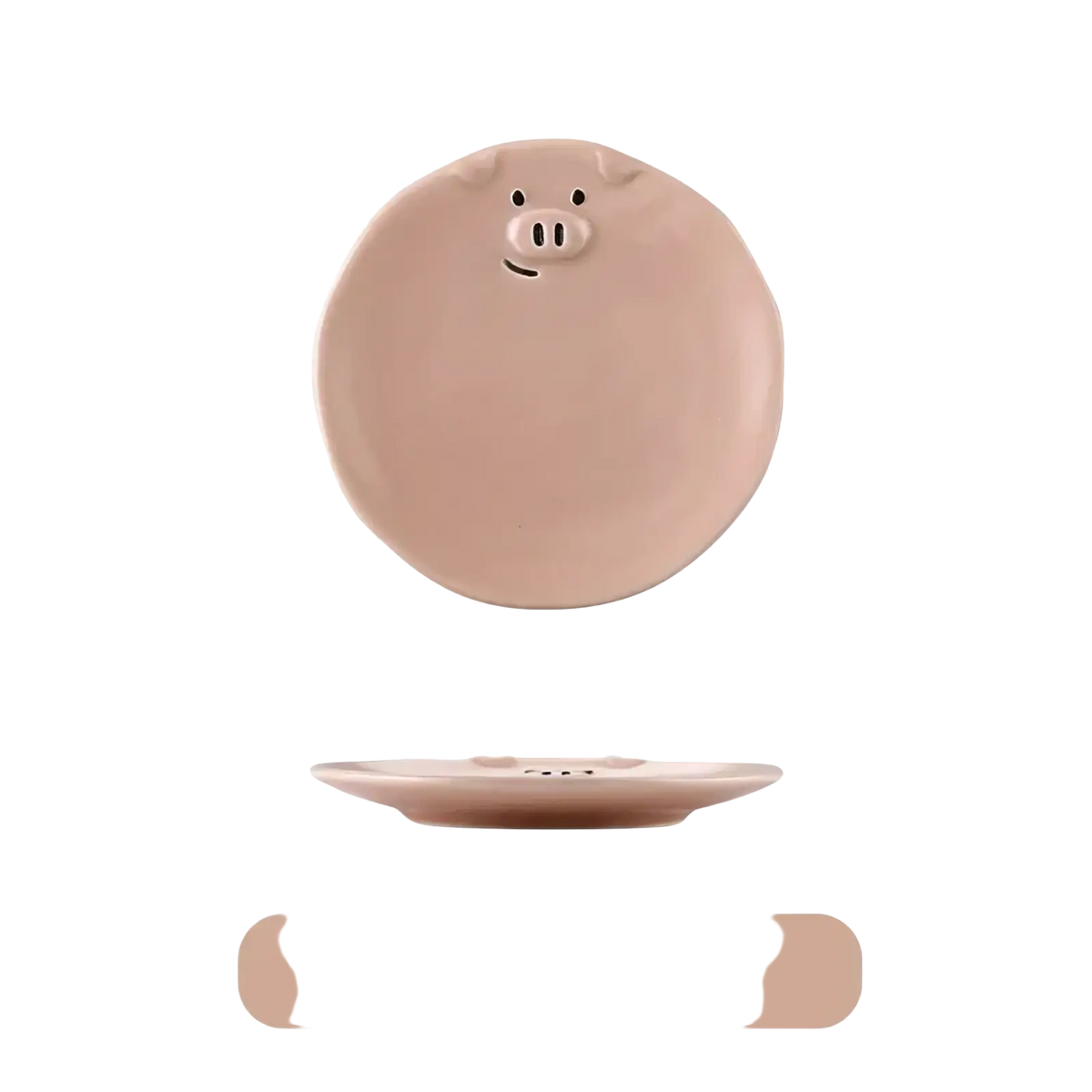 A blush pink ceramic plate shaped like a pig with black dot eyes and a snout from the cute pig ceramic dinnerware set