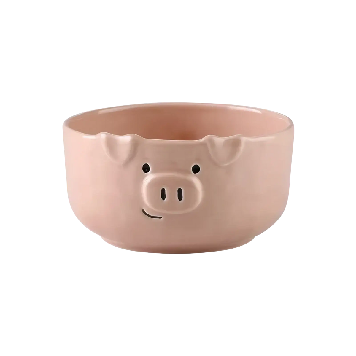 A blush pink ceramic pig-shaped bowl with black eyes and a smiling snout from the cute pig ceramic dinnerware set
