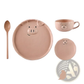 Pastel pink ceramic pig dinnerware set including a large plate, small dish, cup, and wooden spoon for dining
