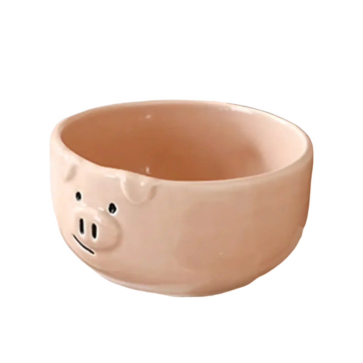 Pastel pink ceramic pig-shaped bowl with black dot eyes and a smiling snout from the cute pig ceramic dinnerware set