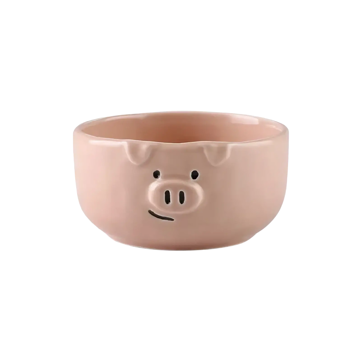 A pink ceramic pig-shaped bowl with black dot eyes snout and smiling mouth from the cute pig ceramic dinnerware set