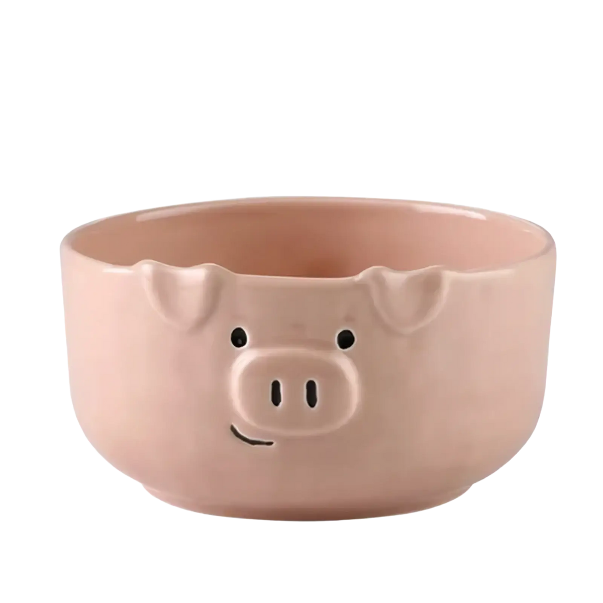 A pink ceramic bowl shaped like a pig with black dot eyes snout and smiling mouth from the cute pig ceramic dinnerware set