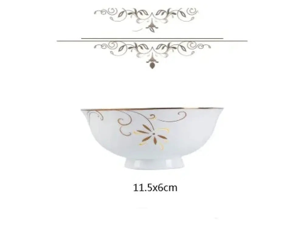 A white ceramic bowl with gold and silver floral patterns complementing a classic stainless steel flatware set