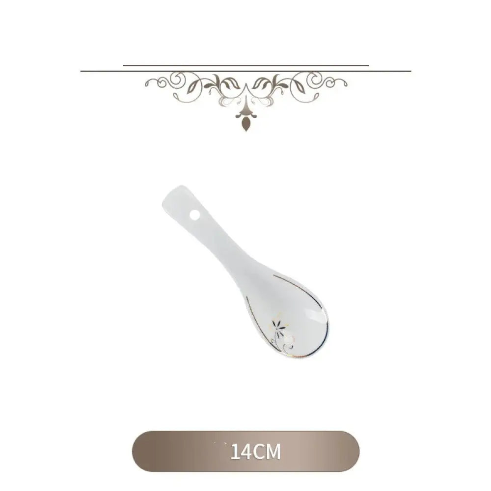White ceramic spoon with silver floral detailing and hole in handle from classic stainless steel flatware set