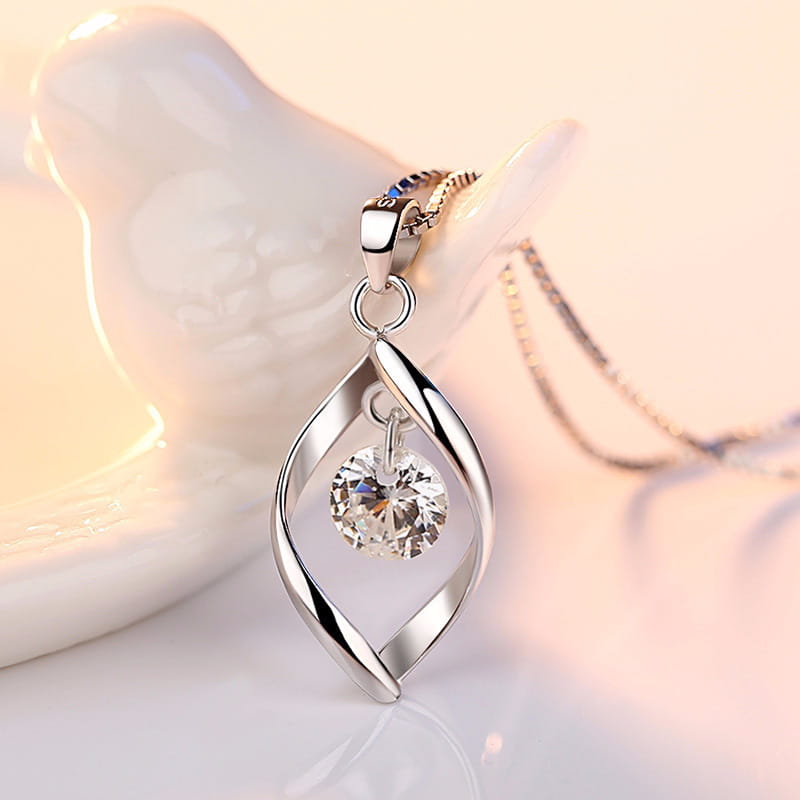 Elegant zircon twist teardrop pendant necklace featuring a silver swirling twisted metal design with a central round crystal.
