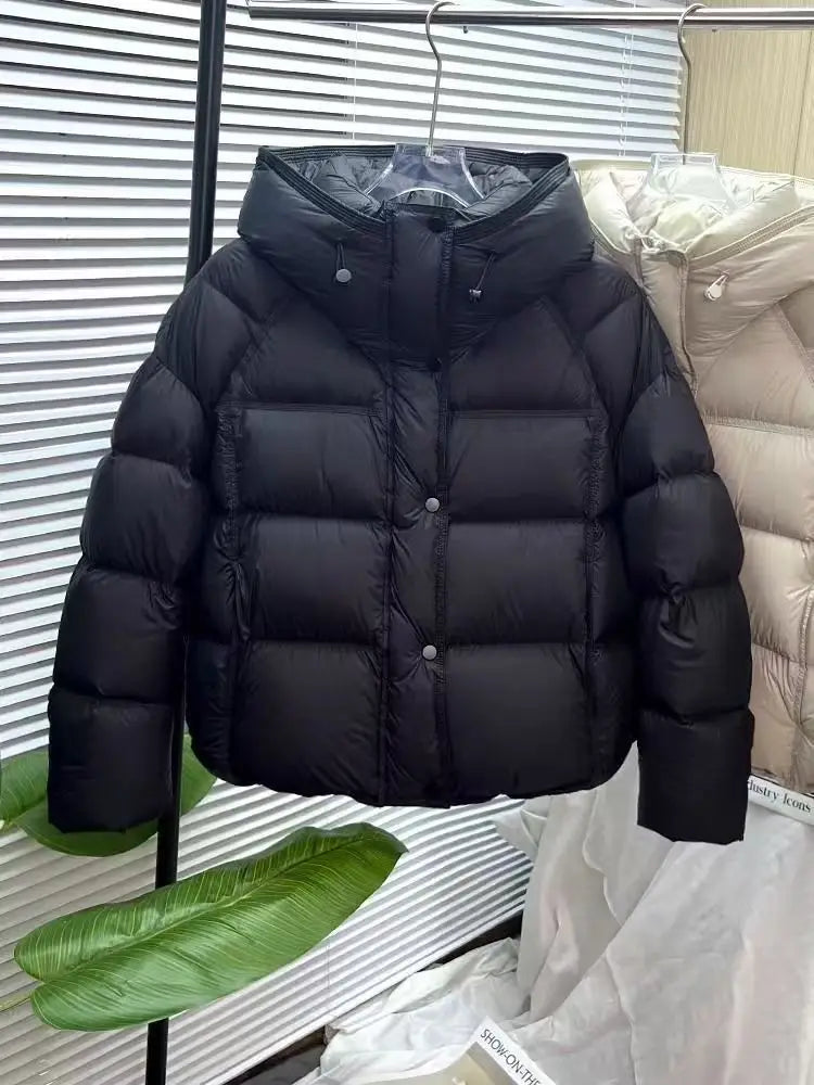 Black quilted puffer jacket loose hooded winter coat with silver-toned buttons and a hood.