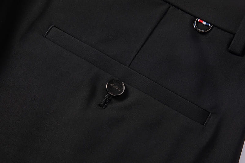 Men plus size stretch casual pants in black tailored trousers with a sleek minimalist design featuring subtle stitching and branded metal accents on the button and pocket.