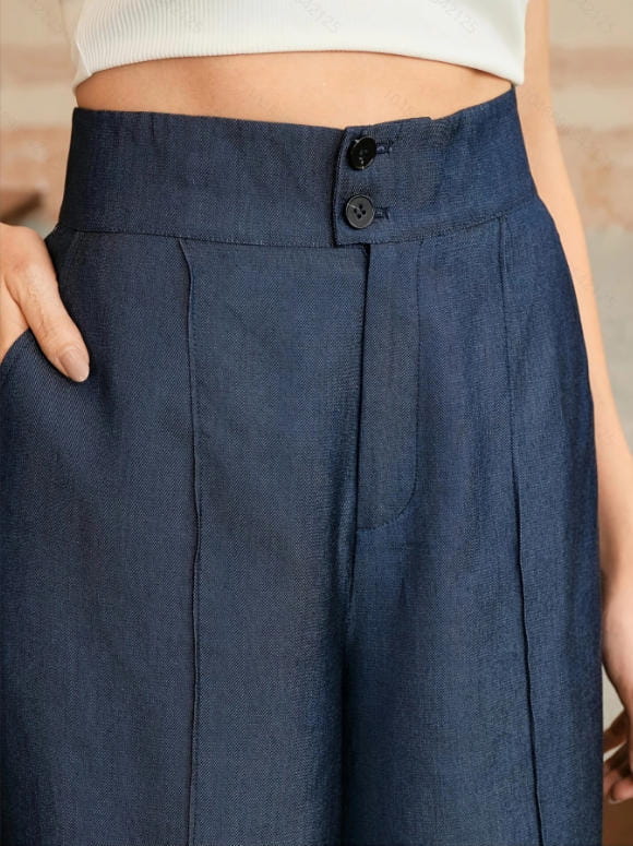 Dark blue high waisted wide leg trousers with button closure and subtle pleats designed for a polished look.