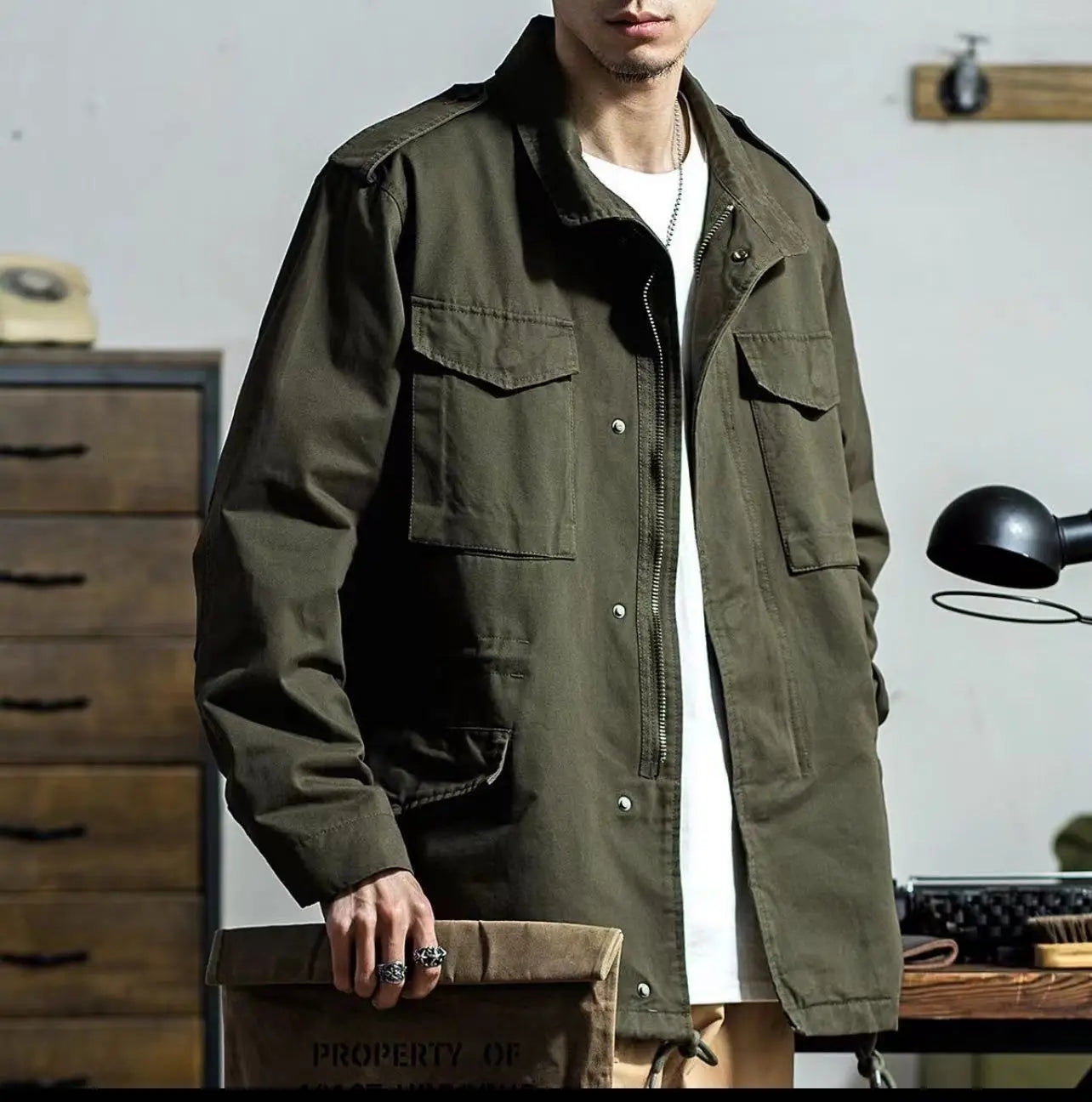 Men’s vintage olive green military field overalls jacket featuring multiple flap pockets and button closures.