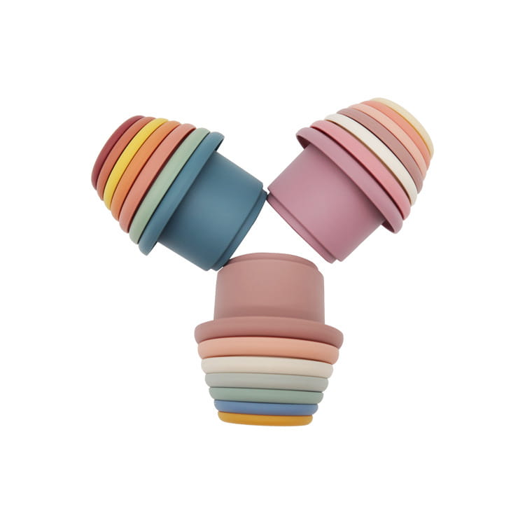 Pastel-colored silicone stacking cups in a rainbow gradient designed as an educational nesting baby toy for children’s play.