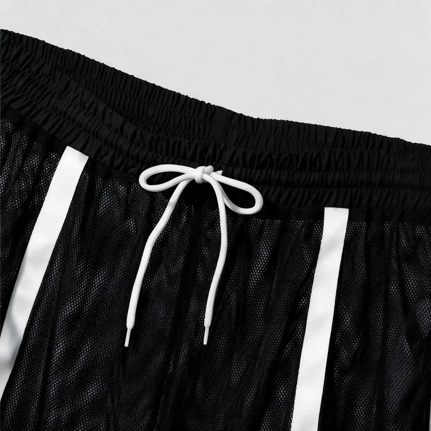 Men quick dry white mesh athletic shorts in black mesh with white drawstring and vertical reflective stripes designed for active use.
