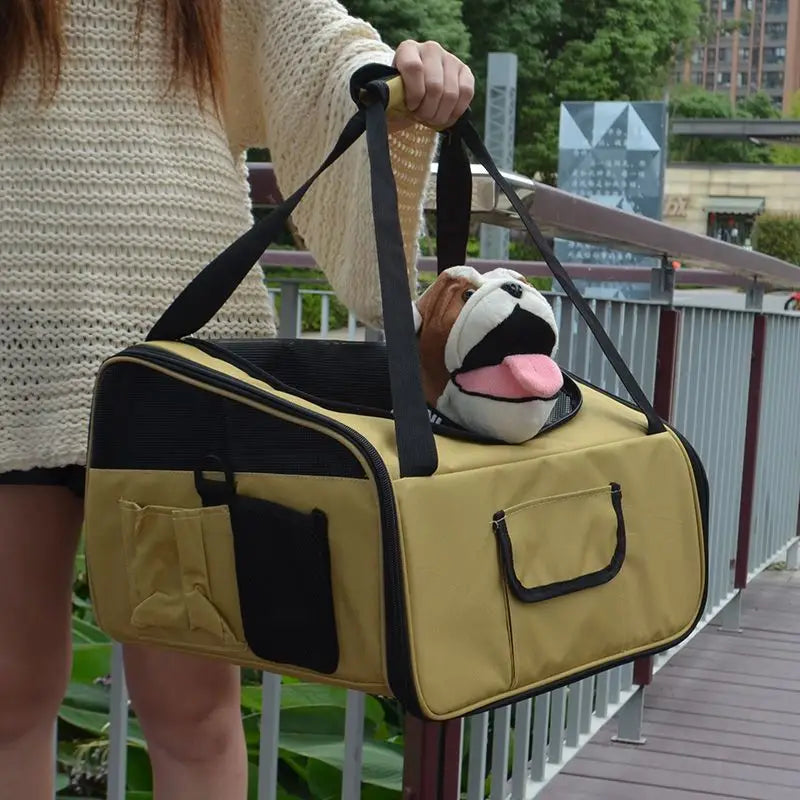 Beige and black pet carrier backpack for small dogs and cats with mesh sides, two front pockets, and a plush bulldog peeking out from the top.