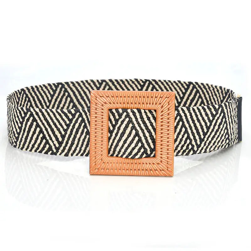 Woven elastic belt with black and cream geometric pattern and a woven tan square buckle.