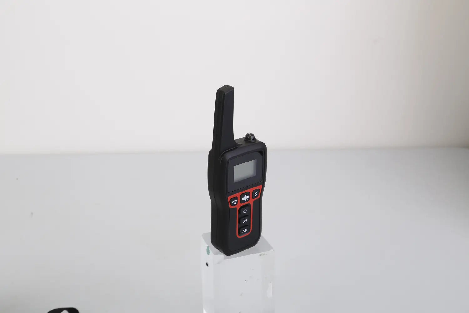black handheld radio with red accent buttons and a small screen for dog training collar 3280ft waterproof shock system