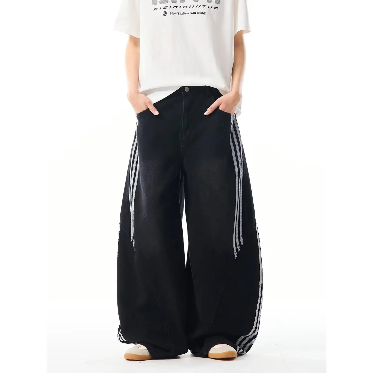 black wide-leg denim jeans with rhinestone starburst design and white striped side panels