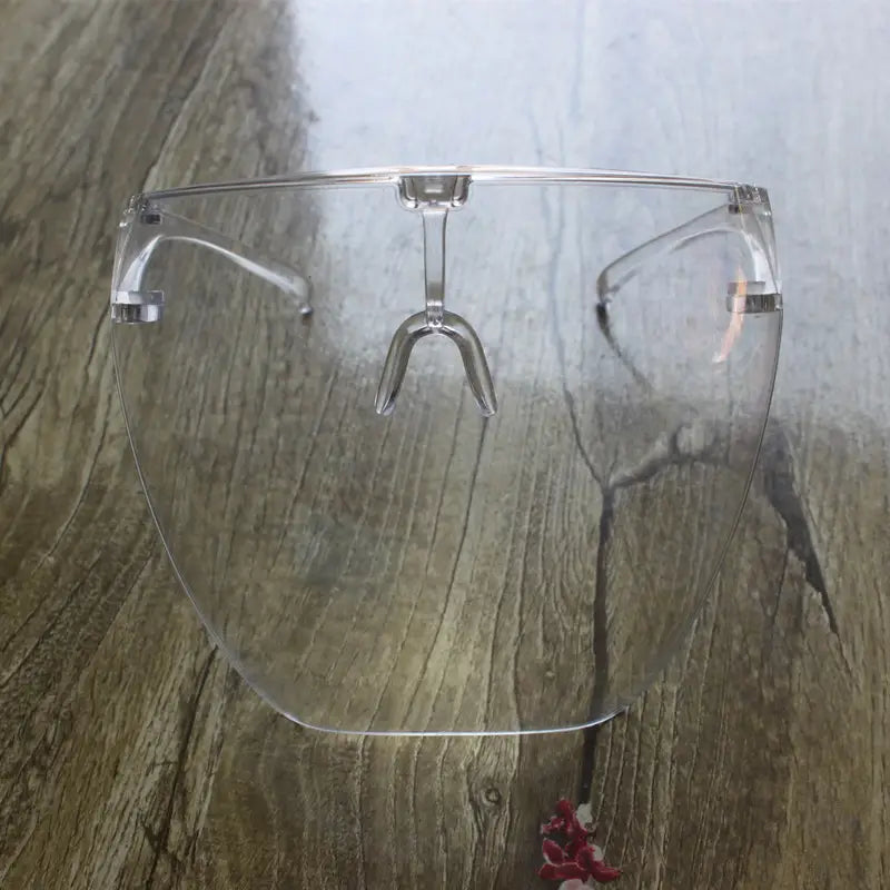 Multifunctional anti-splash iridescent shield sunglasses featuring a clear plastic face shield with a transparent curved visor and metallic silver frame.
