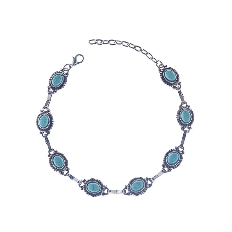 Vintage turquoise silver ornate boho anklet featuring silver-toned bracelet with oval turquoise stones set in darkened metal links and a chain clasp.