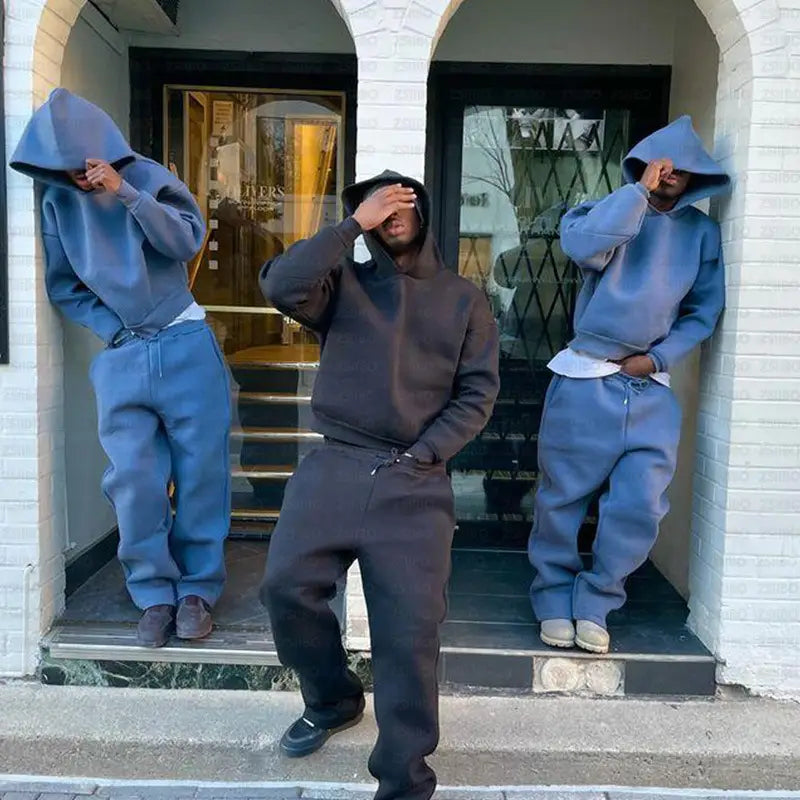 Sweat-shirt à capuche noir, à capuche, avec taille à cordon et poches avant, issu de l’ensemble oversize unisexe streetwear comprenant un sweat à capuche et un pantalon de survêtement, fabriqué dans un tissu confortable pour des tenues décontractées.