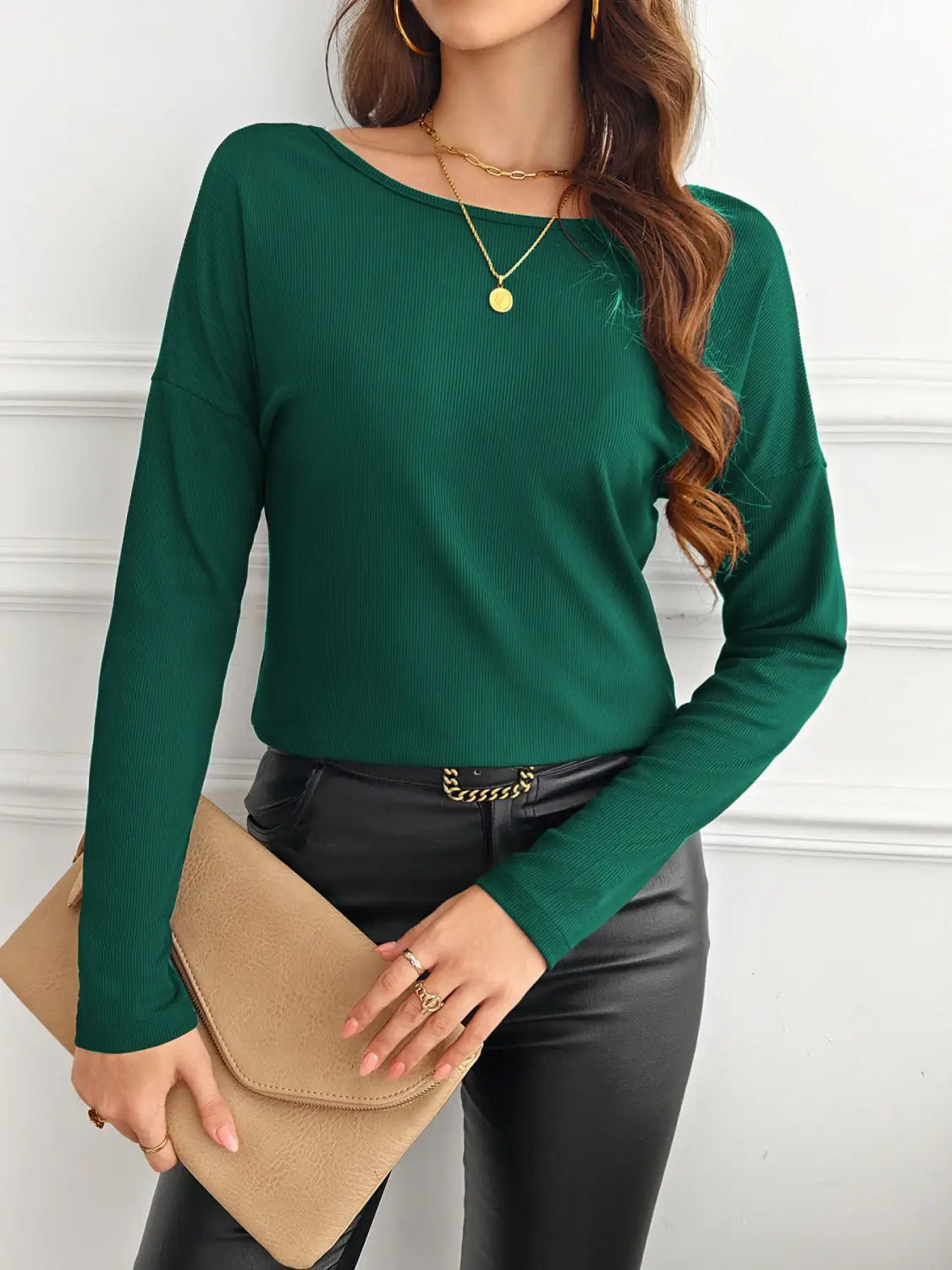 Emerald green ribbed long sleeve top with a rounded neckline and butterfly lace back detail.