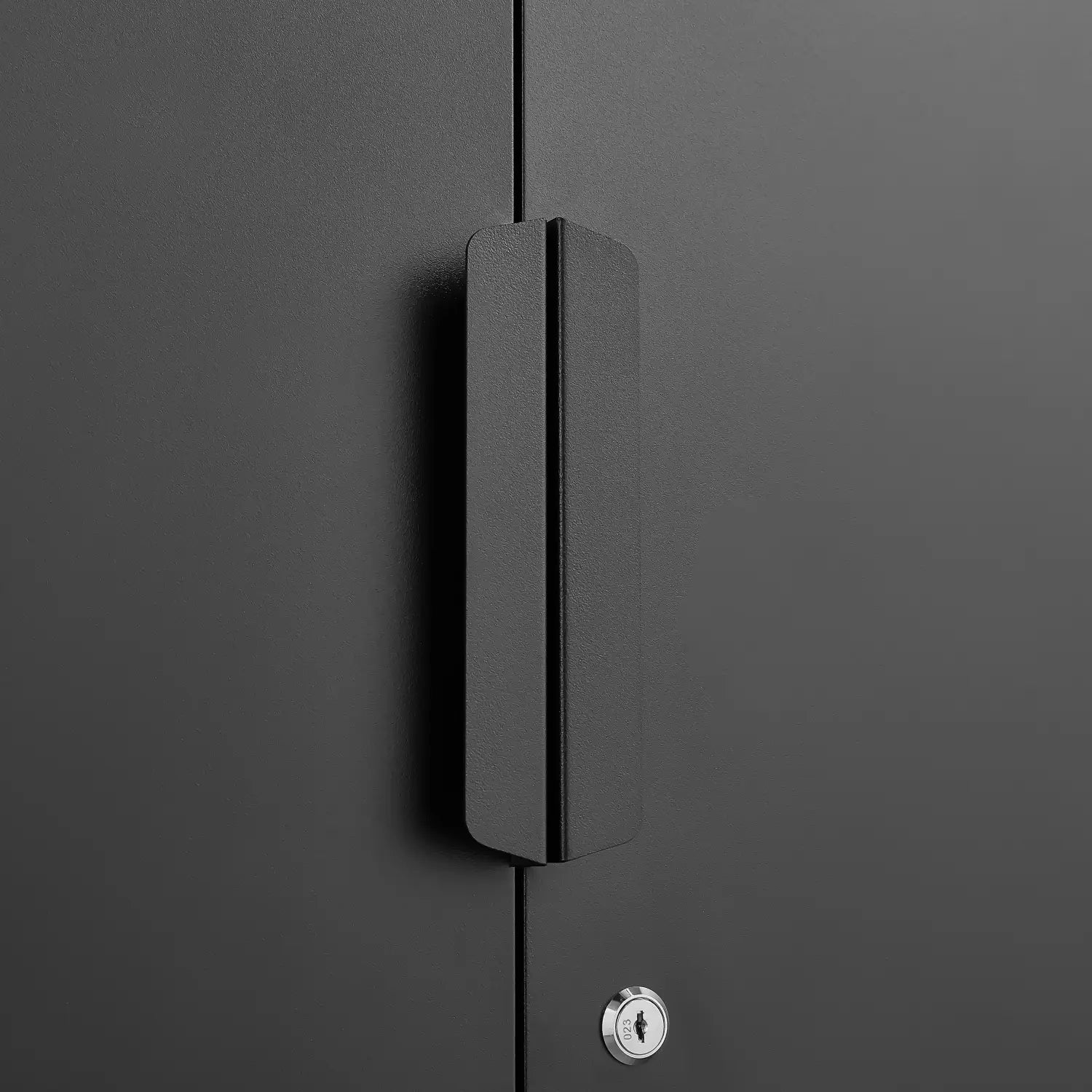 Black matte-finish cabinet handle with sleek minimalist design on a 70 inch steel locking file cabinet with four shelves.