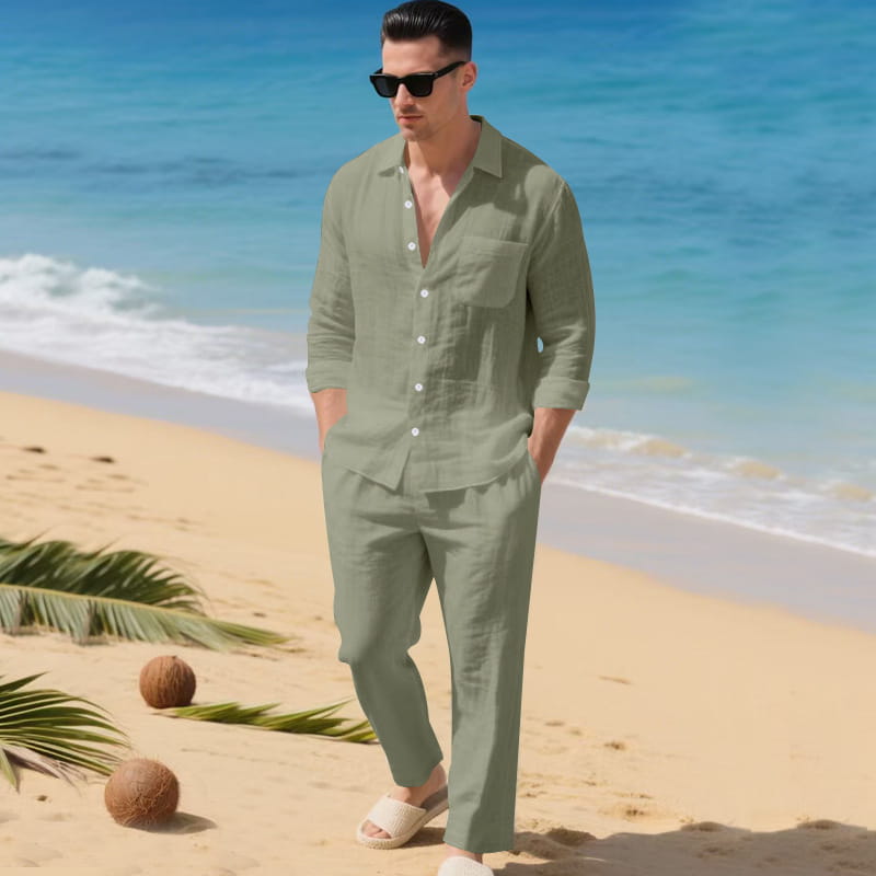 A man wearing a sage green men linen long sleeve shirt and matching pants set made of breathable linen fabric.