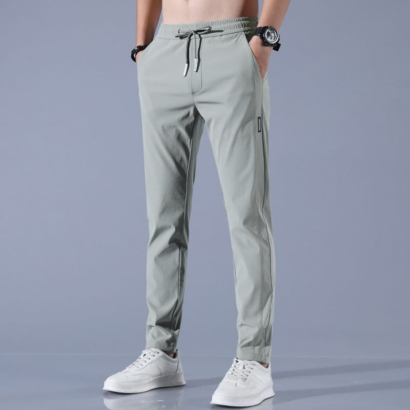 Men ice silk business casual pants in light green slim fit jogger style with drawstring waistband and subtle side stripe detailing.