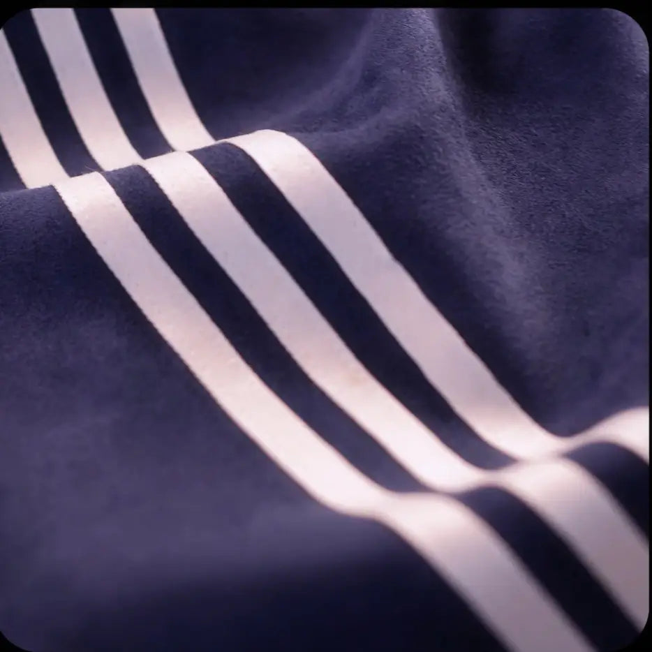 Navy blue fleece sport jacket with three bold white stripes in Tang style design.