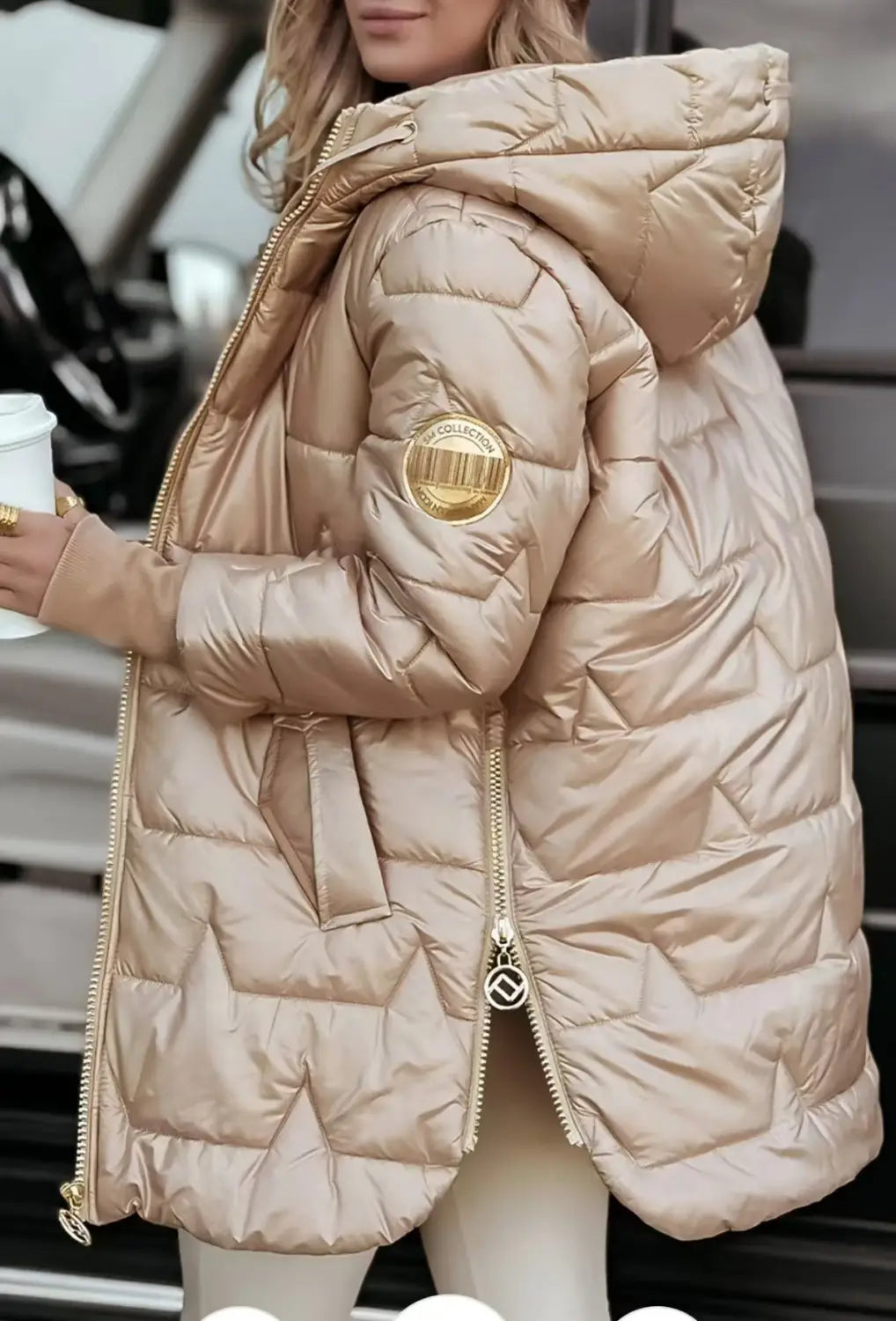 A shiny metallic gold glossy hooded down puffer jacket featuring quilted design and a circular logo patch on the sleeve.