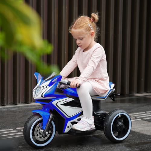 Blue and white 6v kids electric ride on motorcycle with black wheels shown from the back side.