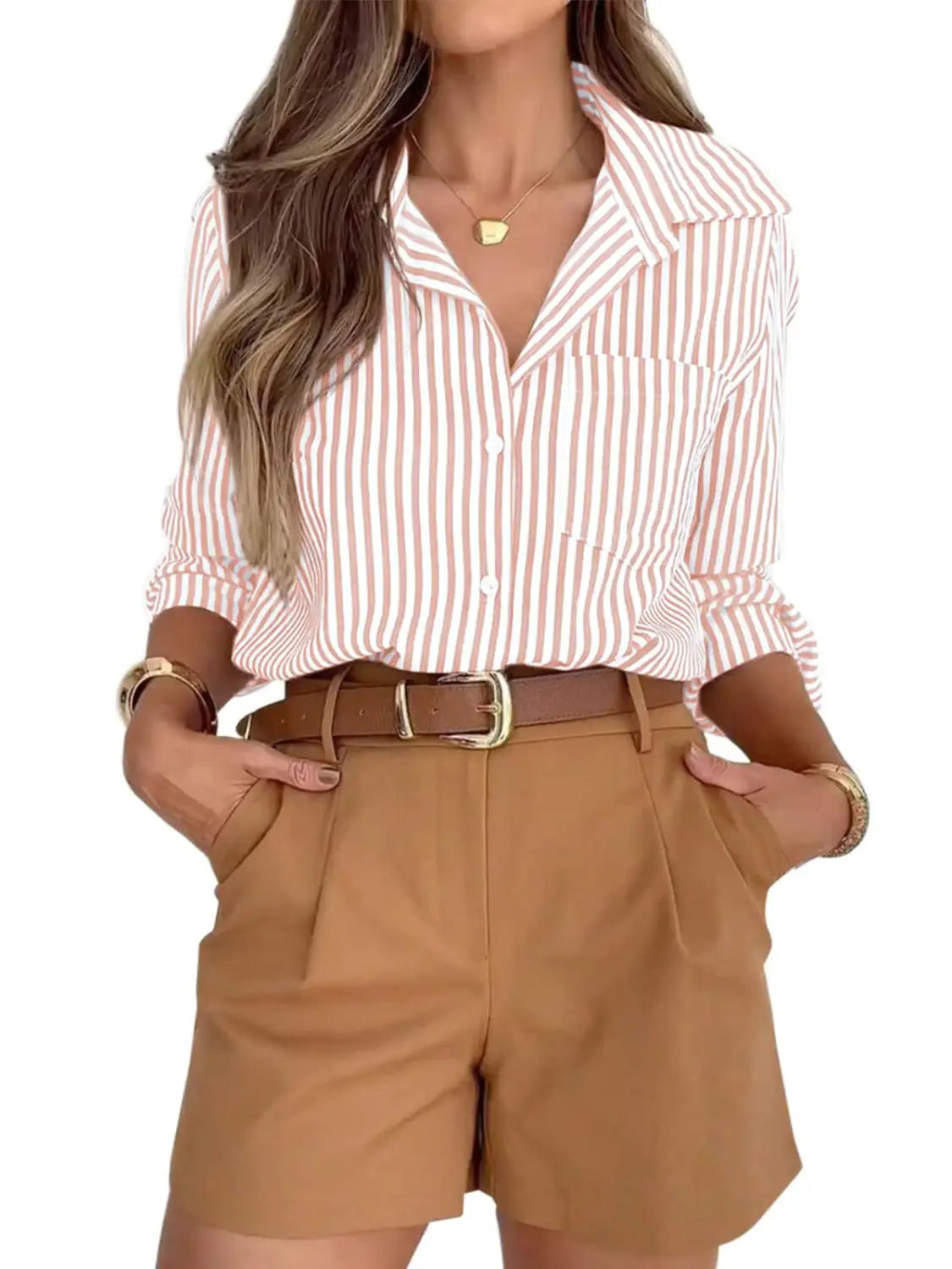 A women’s striped long sleeve button up shirt dress featuring pink and white vertical stripes with rolled sleeves.