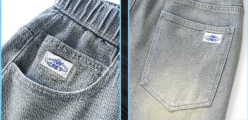 back side of men elastic waist light wash gray denim shorts featuring a subtle herringbone weave and a branded patch on the back pocket