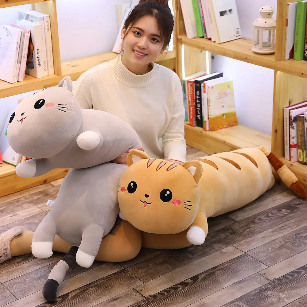 Soft gray and orange plush cat-shaped pillows feature embroidered facial features and stitched details as soft stuffed animal toy pillows.