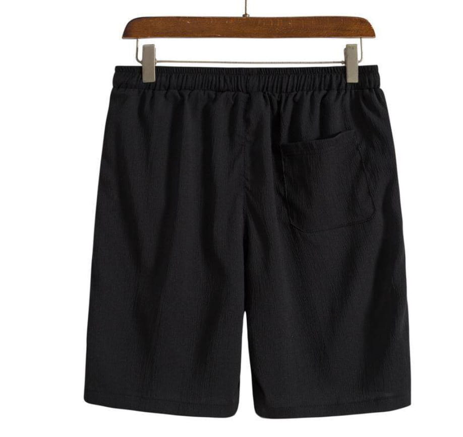 Short de plage en coton lin pour hommes présenté de dos, côté noir, avec une ceinture élastique et une poche arrière unique