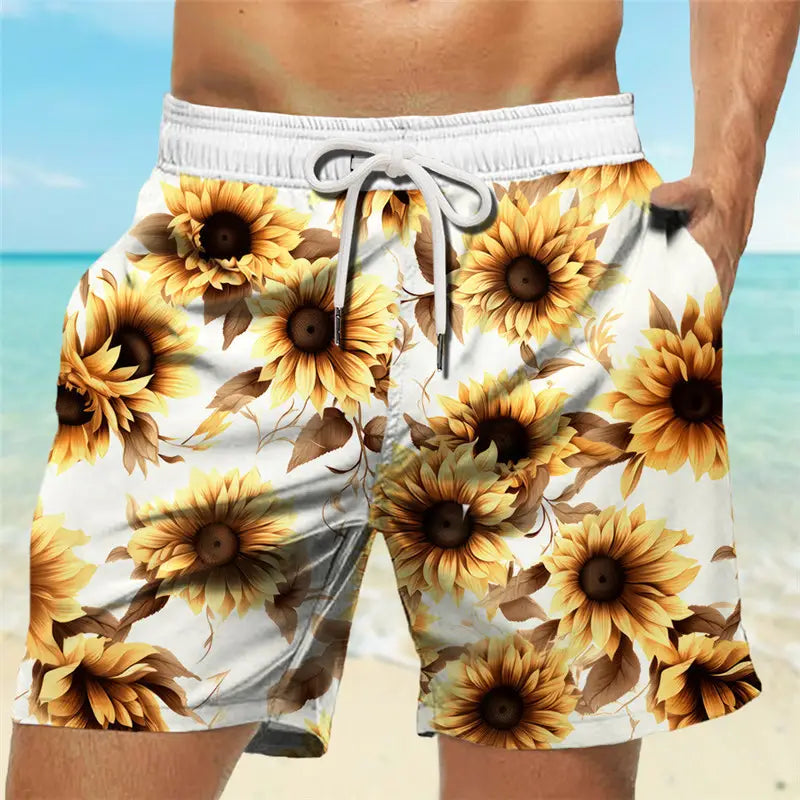 Men’s striped tropical print swim trunks in white featuring a vibrant sunflower pattern with yellow petals and brown centers accented by matching drawstrings.