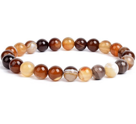 Unisex 8mm polished agate and amethyst stretch bracelet featuring smooth translucent round agate beads in warm earthy tones from deep brown to amber and cream.
