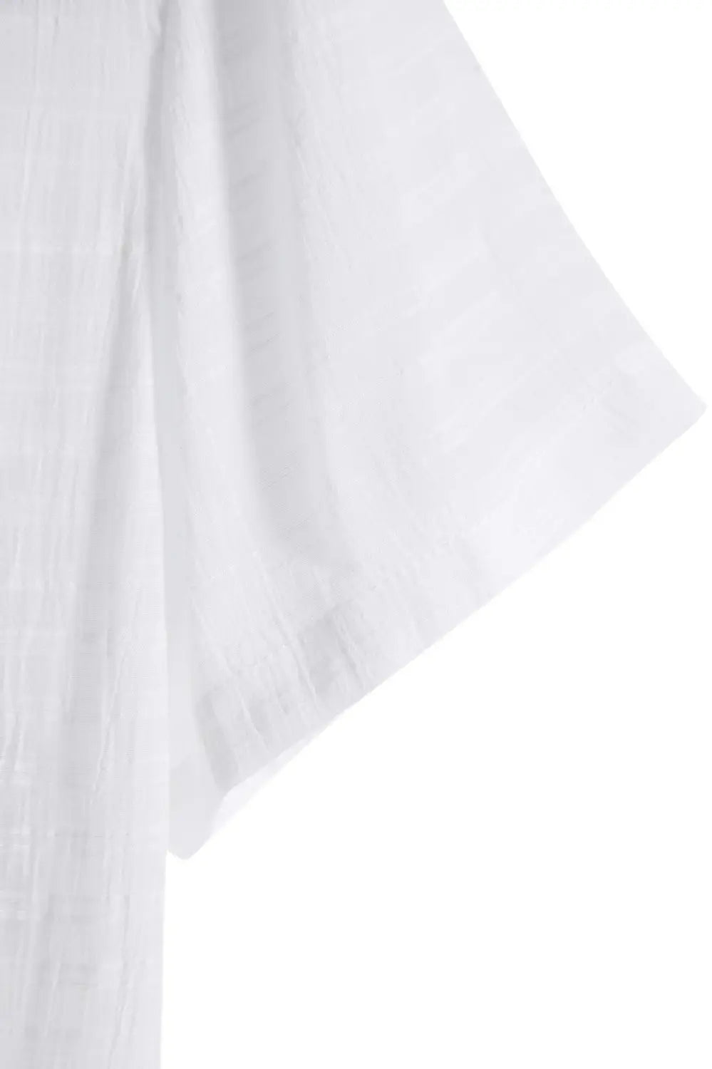 Men’s minimalist textured short sleeve grid shirt made of white lightweight cotton fabric with a subtle textured weave and softly frayed hem.