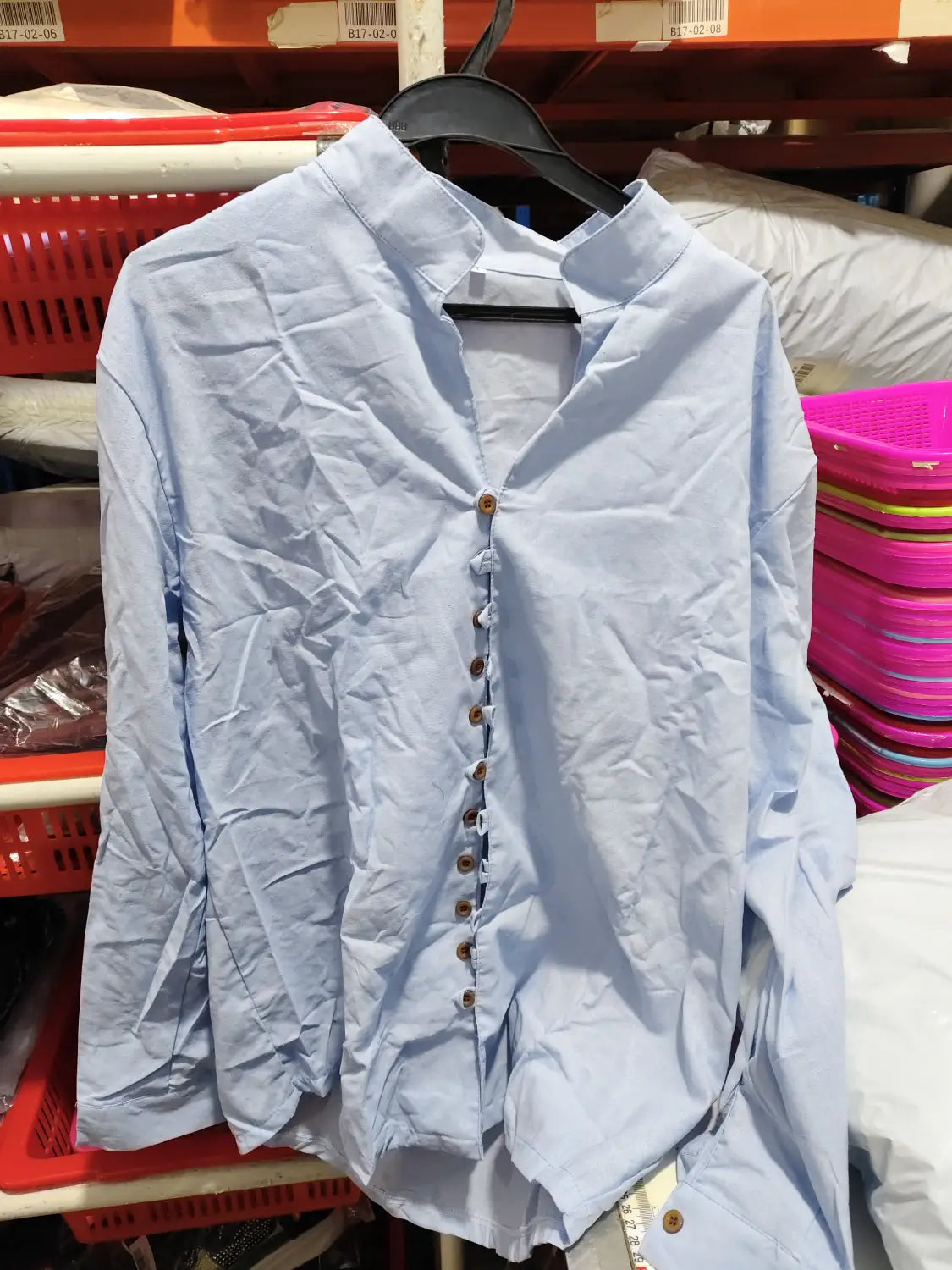 Light blue linen blend long-sleeved casual shirt with a mandarin collar, wooden buttons, and wrinkle resistant fabric.