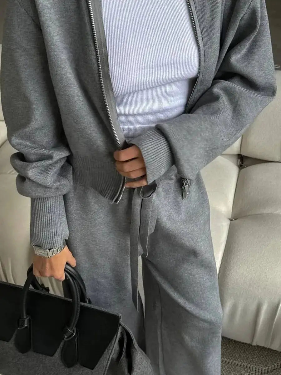 women’s gray knit zip-up cardigan with ribbed cuffs and waistband shown from the back as part of a knit zip-up cardigan and wide leg pant set