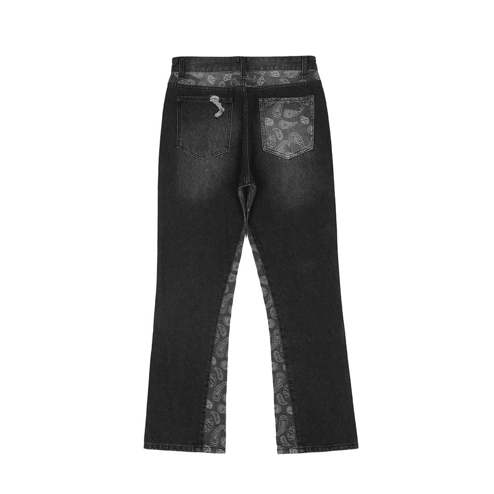 men’s black denim distressed flare jeans with faded wash and paisley-patterned fabric accents along side seams and back pockets shown from the back side