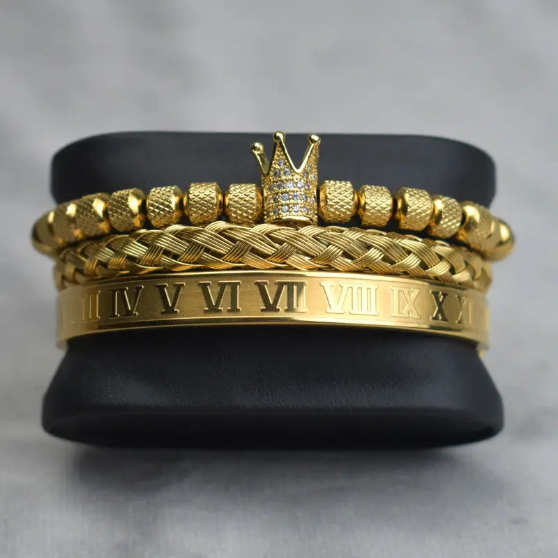 Gold-toned crown bracelet with textured diamond beads and roman numeral engraving from the crown royal diamond beaded bracelet set with braided bands.