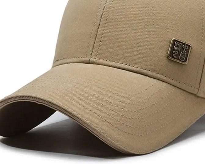 Beige men outdoor baseball cap with small rectangular metal patch on the front designed for sun protection.