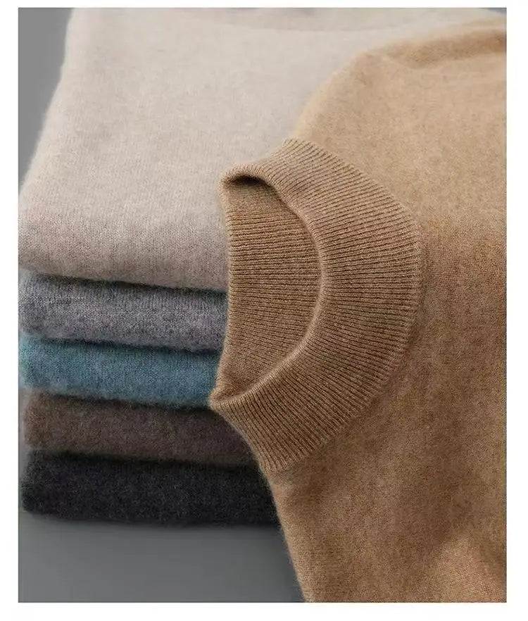 Stapeln weicher, gestrickter Kaschmir-Herren-Halbkragenpullover in neutralen Tönen, darunter Beige, Grau, Teal, Braun und Schwarz.