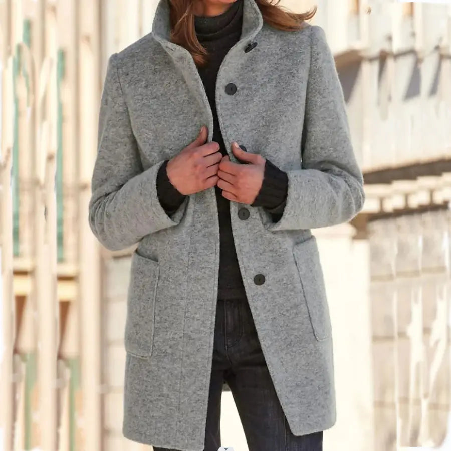A stylish gray woolen winter coat for women featuring a classic collar and black buttons.
