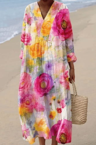 A flowing v-neck floral maxi dress in vibrant pink yellow and purple hues made of lightweight semi-sheer fabric for women.