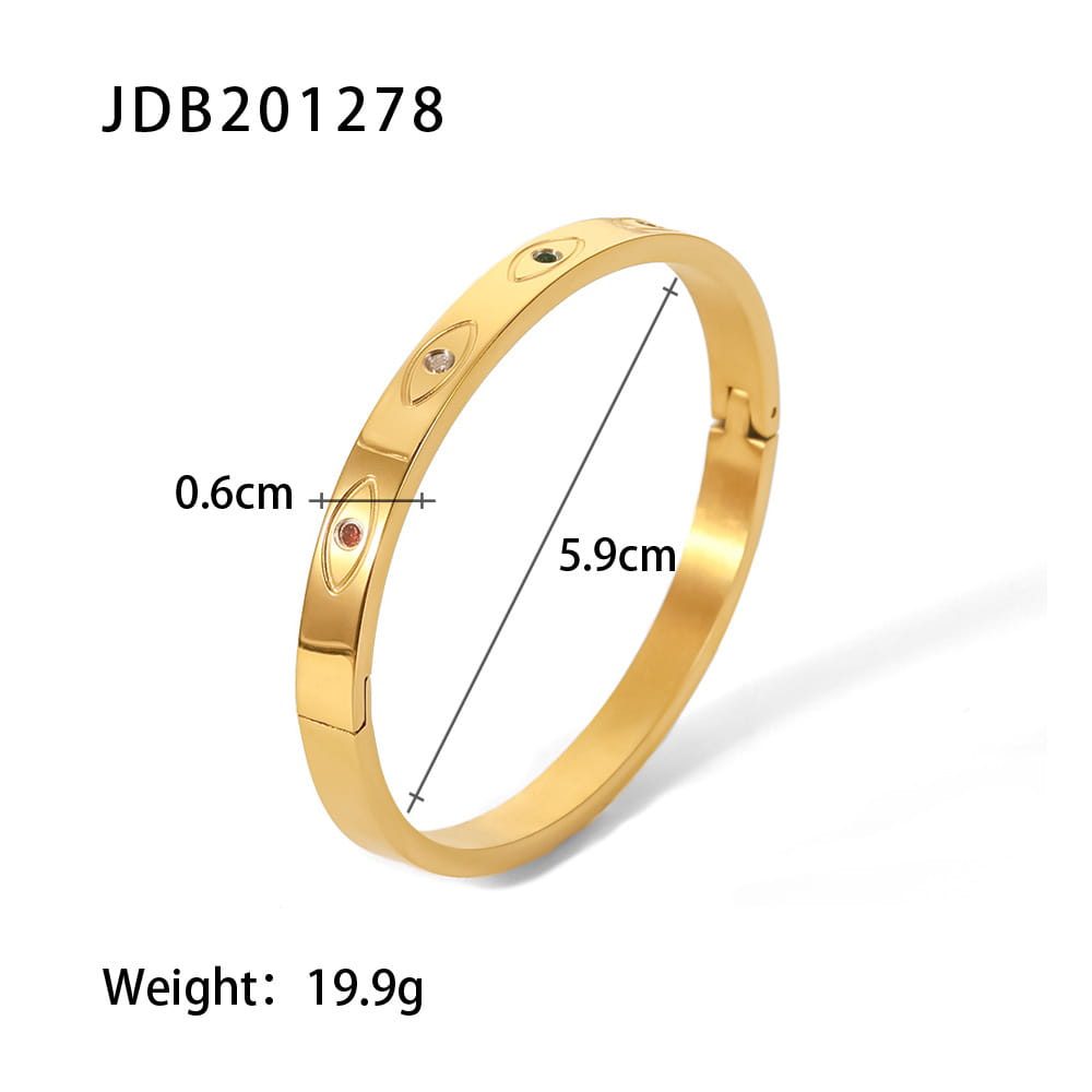 Gold plated stainless steel bangle bracelet in gold tone with embedded oval-shaped zirconia gemstones in a sleek minimalist design.
