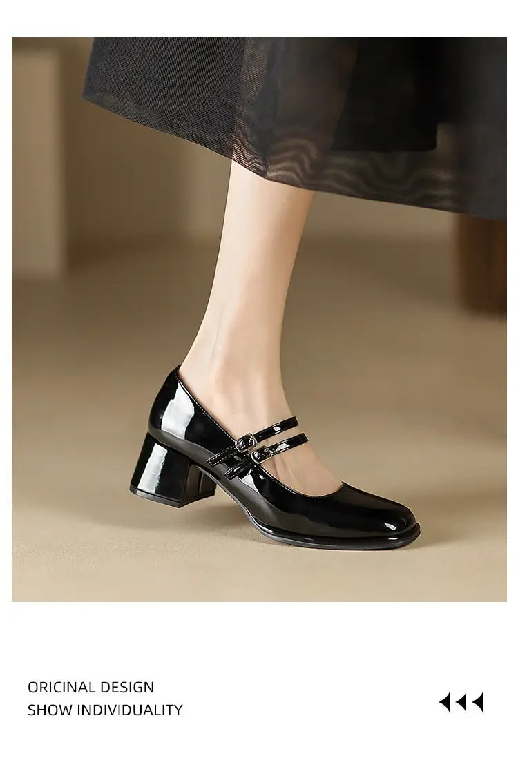 Black patent leather mary jane heels featuring a block heel and double strap buckle detail.