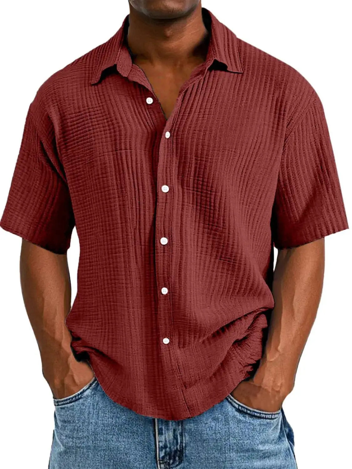 A men’s textured short sleeve button up shirt in maroon featuring ribbed fabric and white buttons.