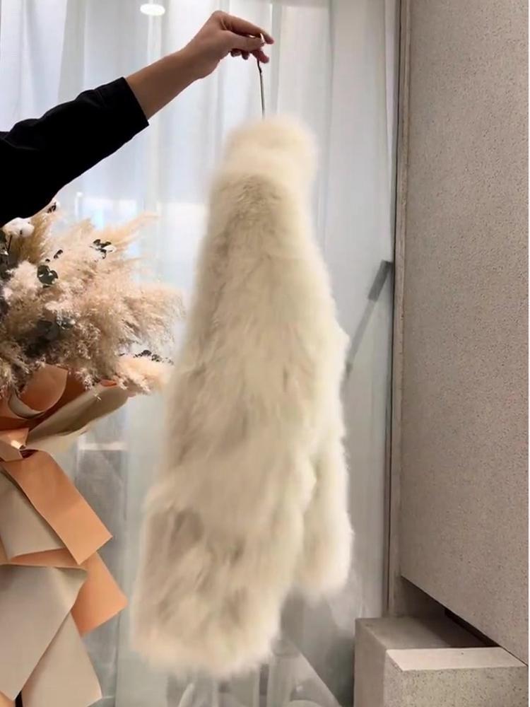 A plush off-white faux fur scarf with a soft fluffy texture and long flowing design featured in the faux fur cream buckle coat collection.