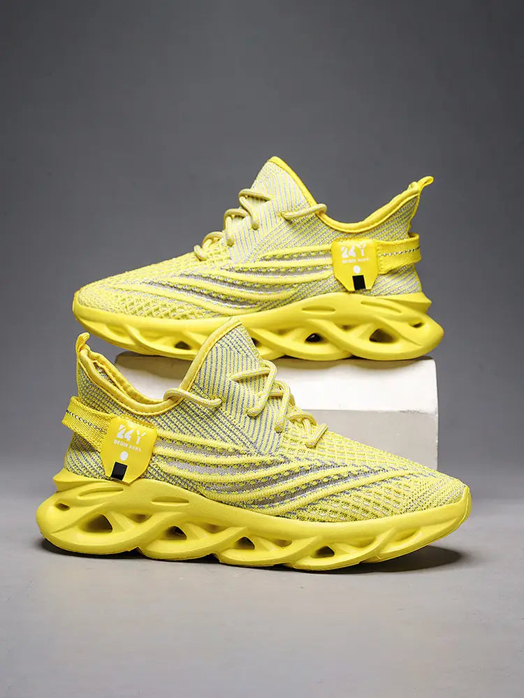 Bright yellow flyknit mesh platform running shoes for men with a bold sculpted rubber sole and subtle gray accent stripes.